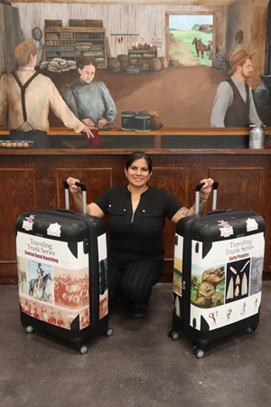 Claudia Mosely with two traveling trunks