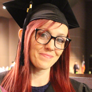 VC Graduate with cap and glasses smiling