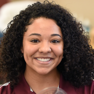 PTA Student smiling in maroon shirt