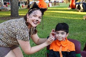 A child getting his face painted at a previous halloween carnival