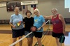ALL Pickleball players smile with paddles in the VC gym