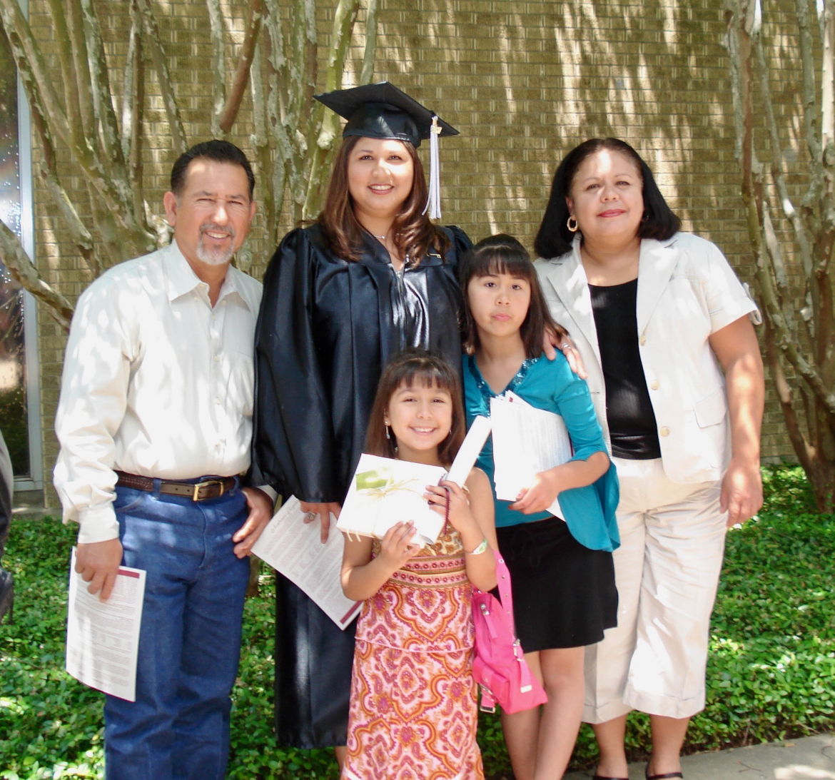 Ann Garza surrounded by family after graduating from VC