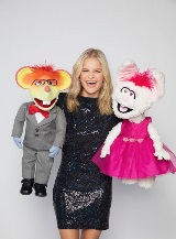 Darci Lynne holds two puppets