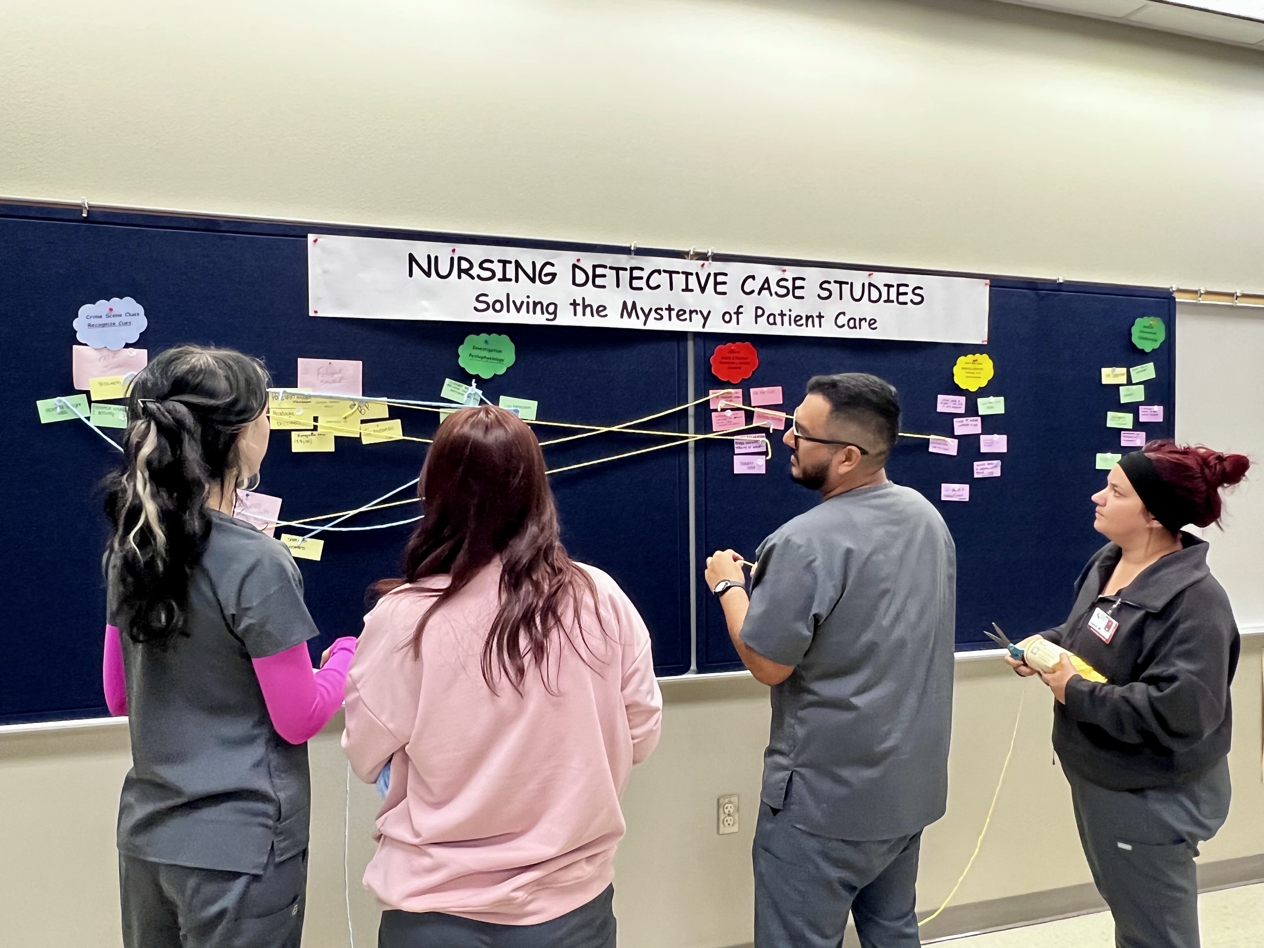 Four ADN students observe the symptoms on the detective case study board