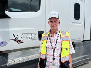 Rocky Pullin stands beside a VC truck