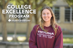 Smiling Victoria College student with maroon sweatshirt and aspen institute logo