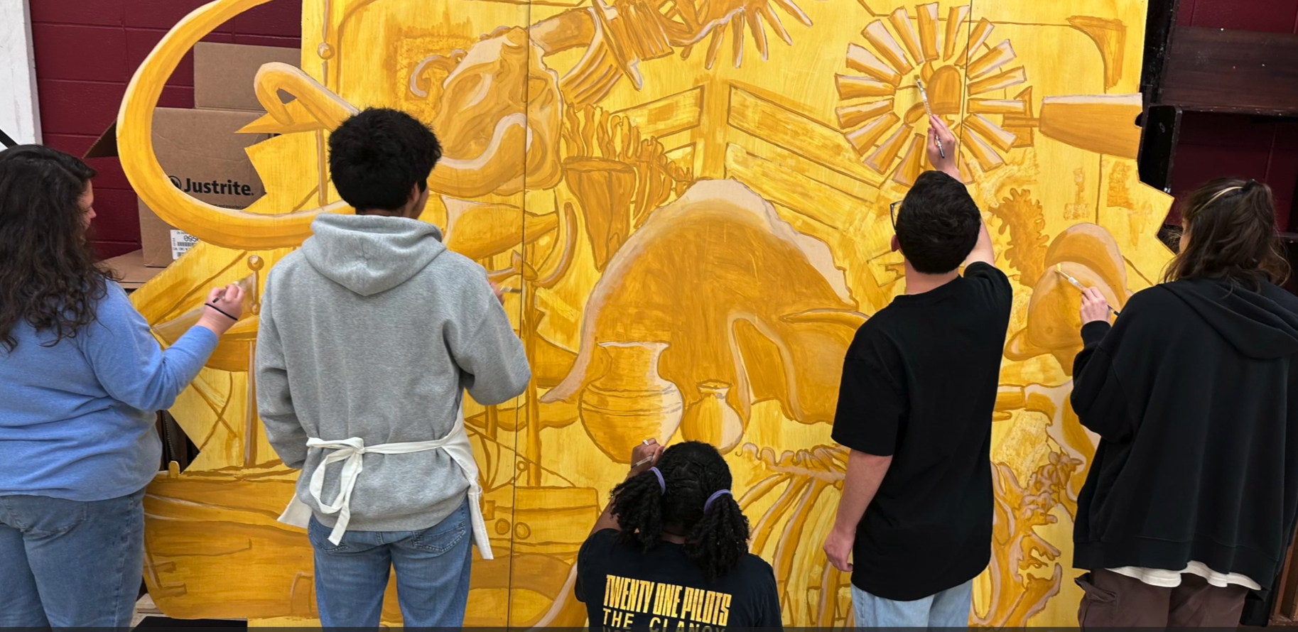 Students painting the museum's mural