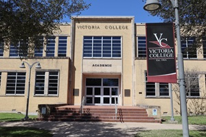 VC Academic Building exterior with a maroon and black VC flag