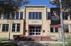 VC Academic Building exterior with a maroon and black VC flag