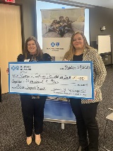 Victoria College rep accepts a grant check