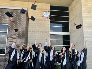Victoria College students toss their graduation caps