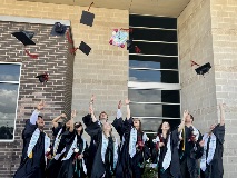 Victoria College students toss their graduation caps