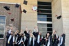 Victoria College students toss their graduation caps