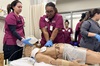 Vocational Nursing students practice chest compressions